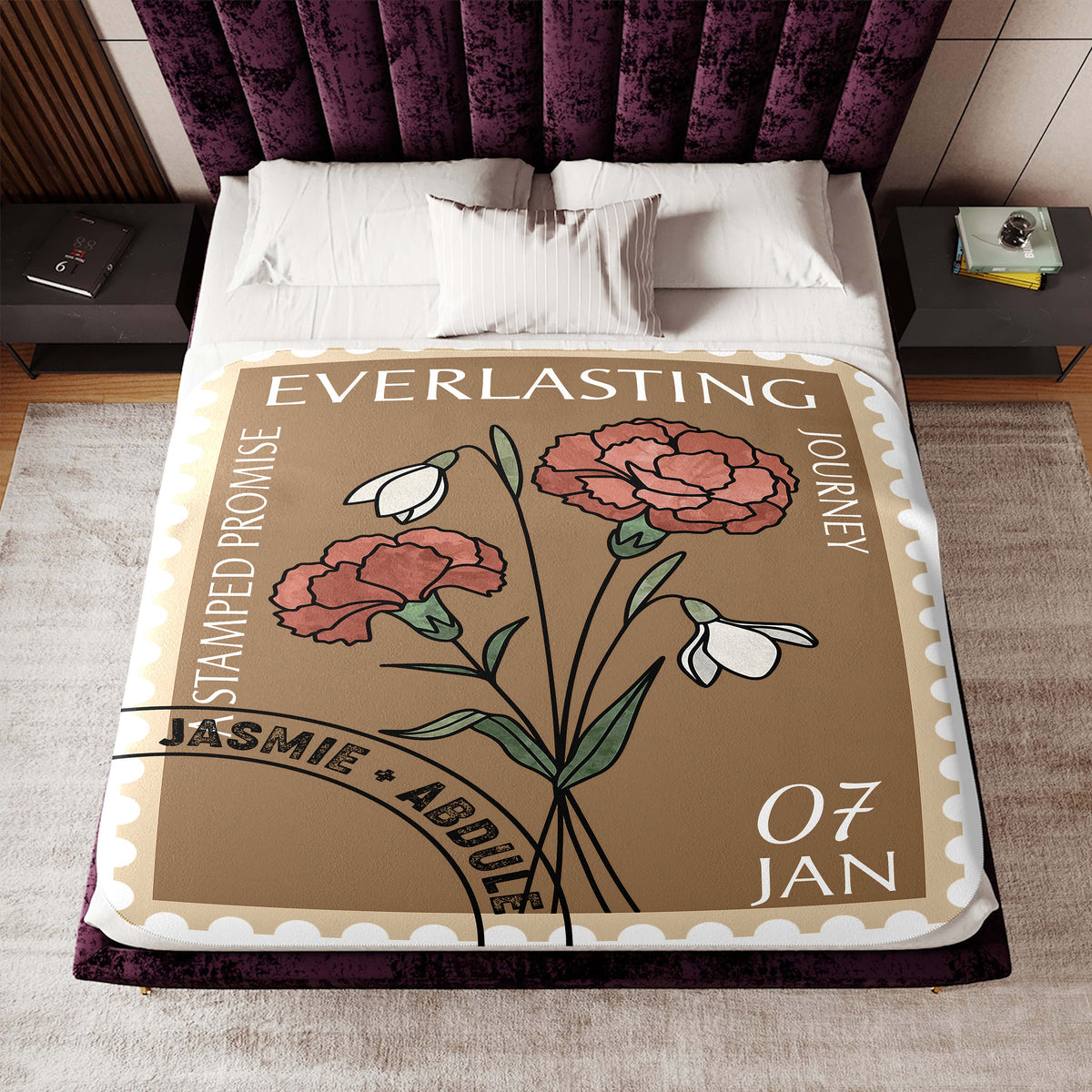a bed covered in a blanket with flowers on it