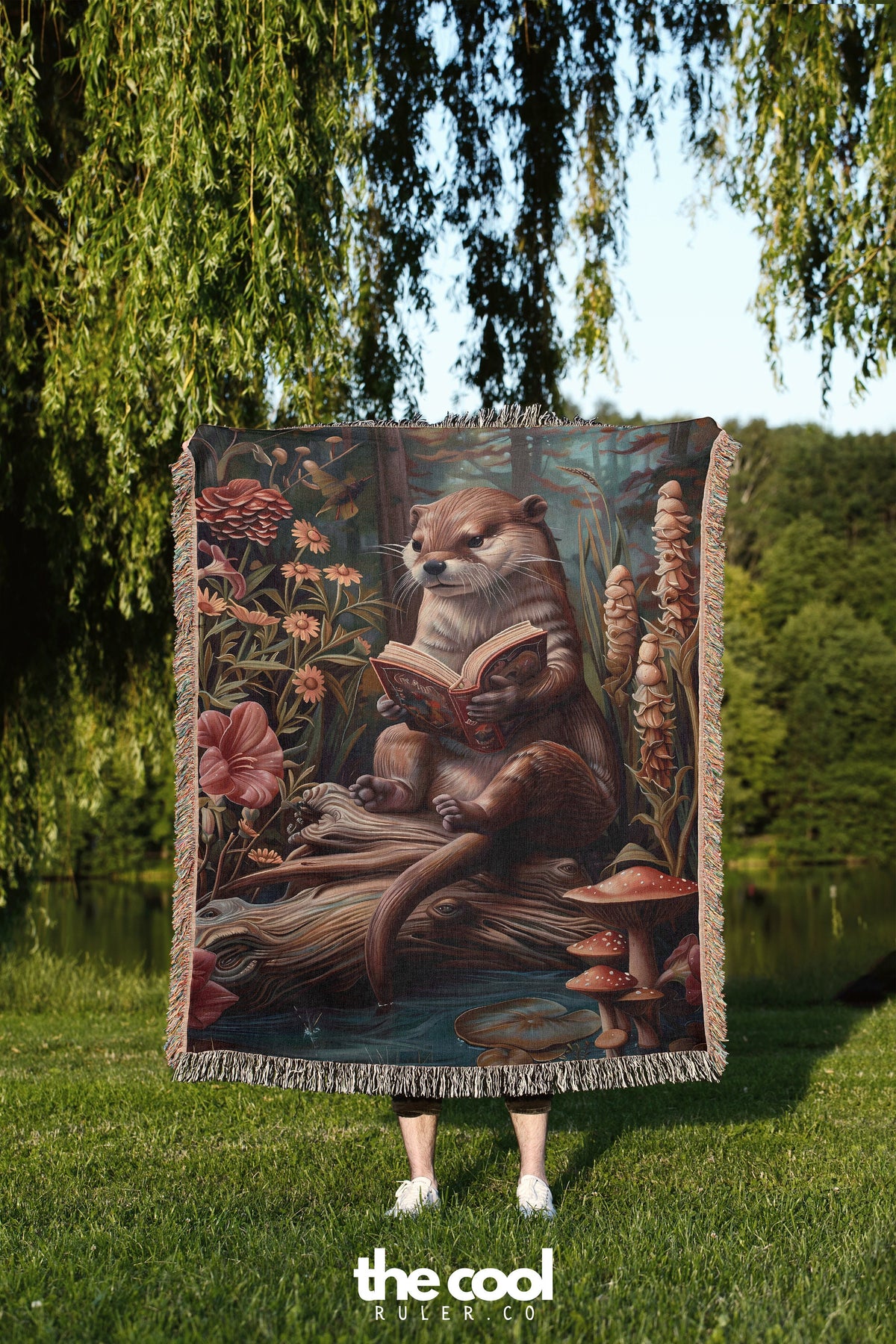 a person holding a blanket with a picture of a beaver on it