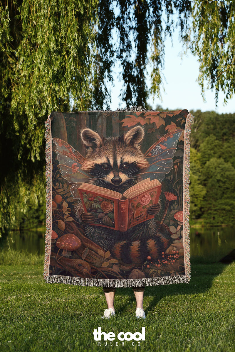a raccoon is reading a book on a blanket