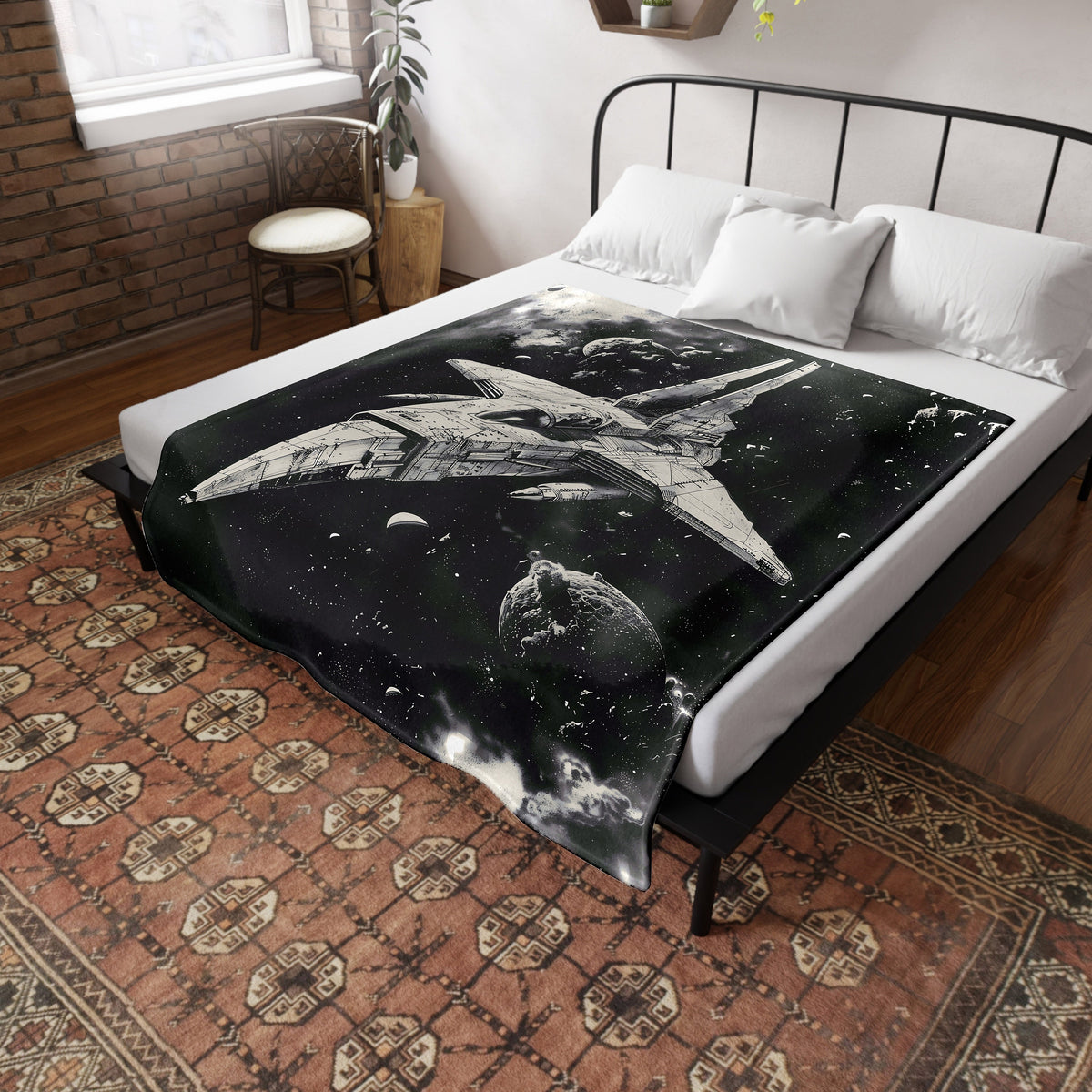 a bed with a black and white picture of a space ship on it