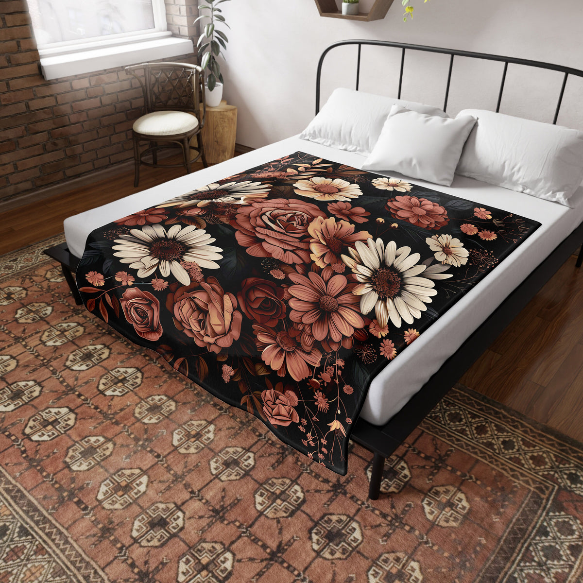 a bed with a floral blanket on top of it