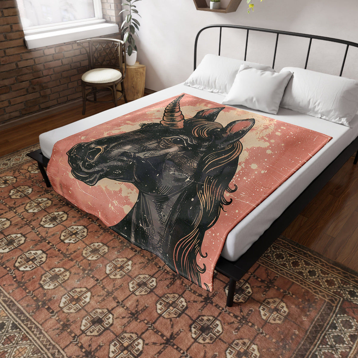 a bed with a blanket that has a picture of a unicorn on it