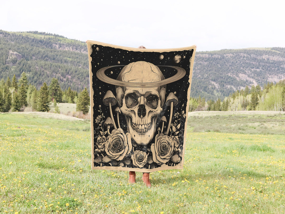 a skull wearing a hat and holding a tapestry