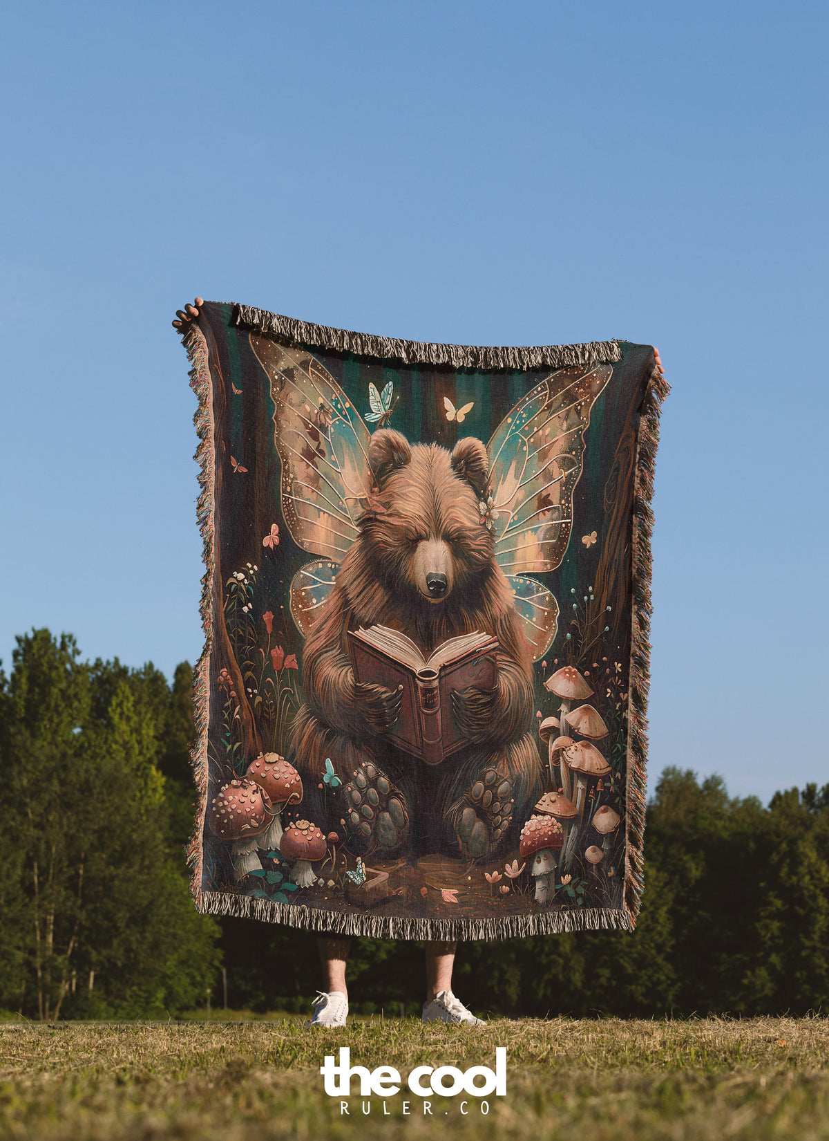 a bear reading a book while standing in a field