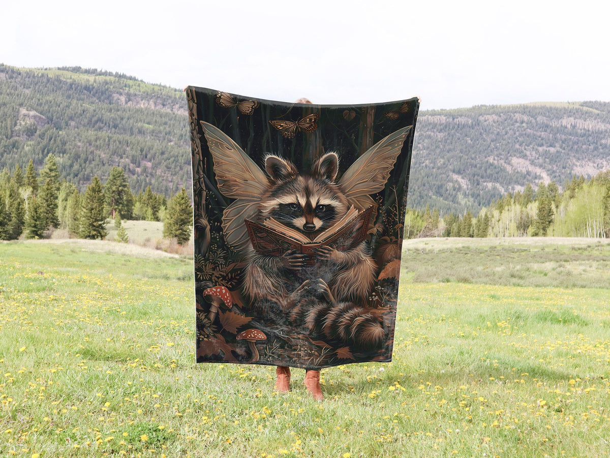 a raccoon holding up a towel in a field