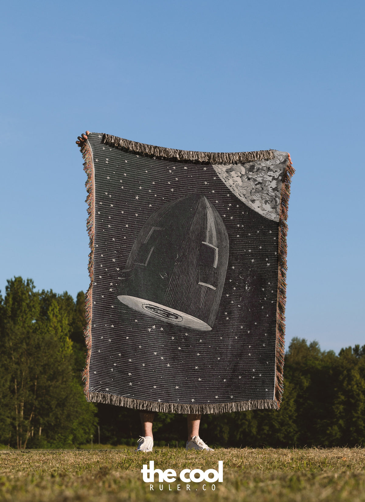 a person holding a large black and white blanket