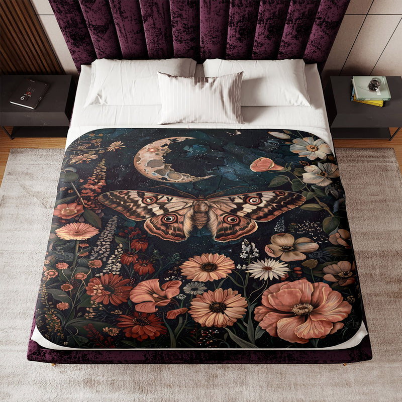 a bed covered in a blanket with a picture of a butterfly on it