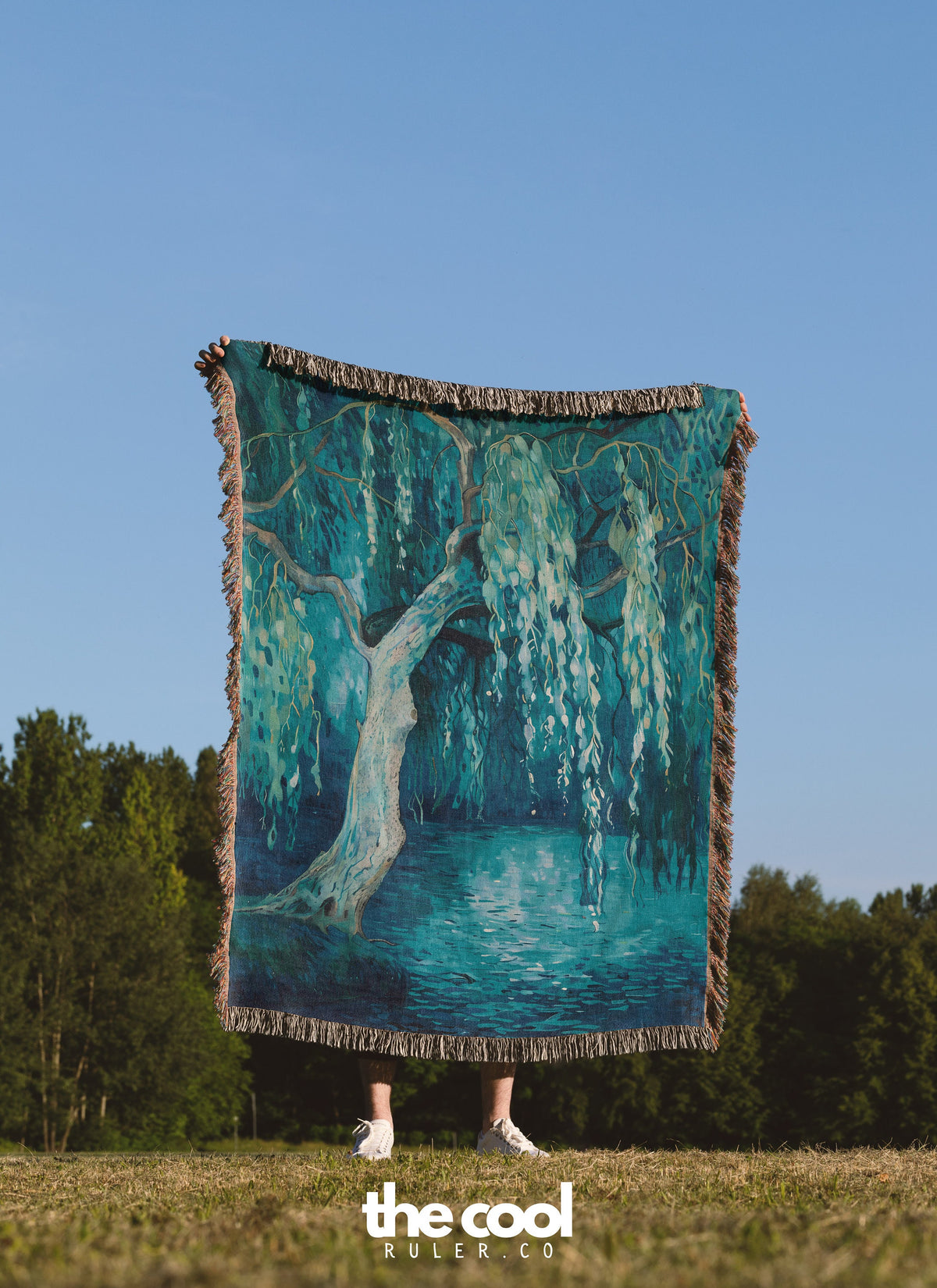 a person holding a large blanket with a painting on it