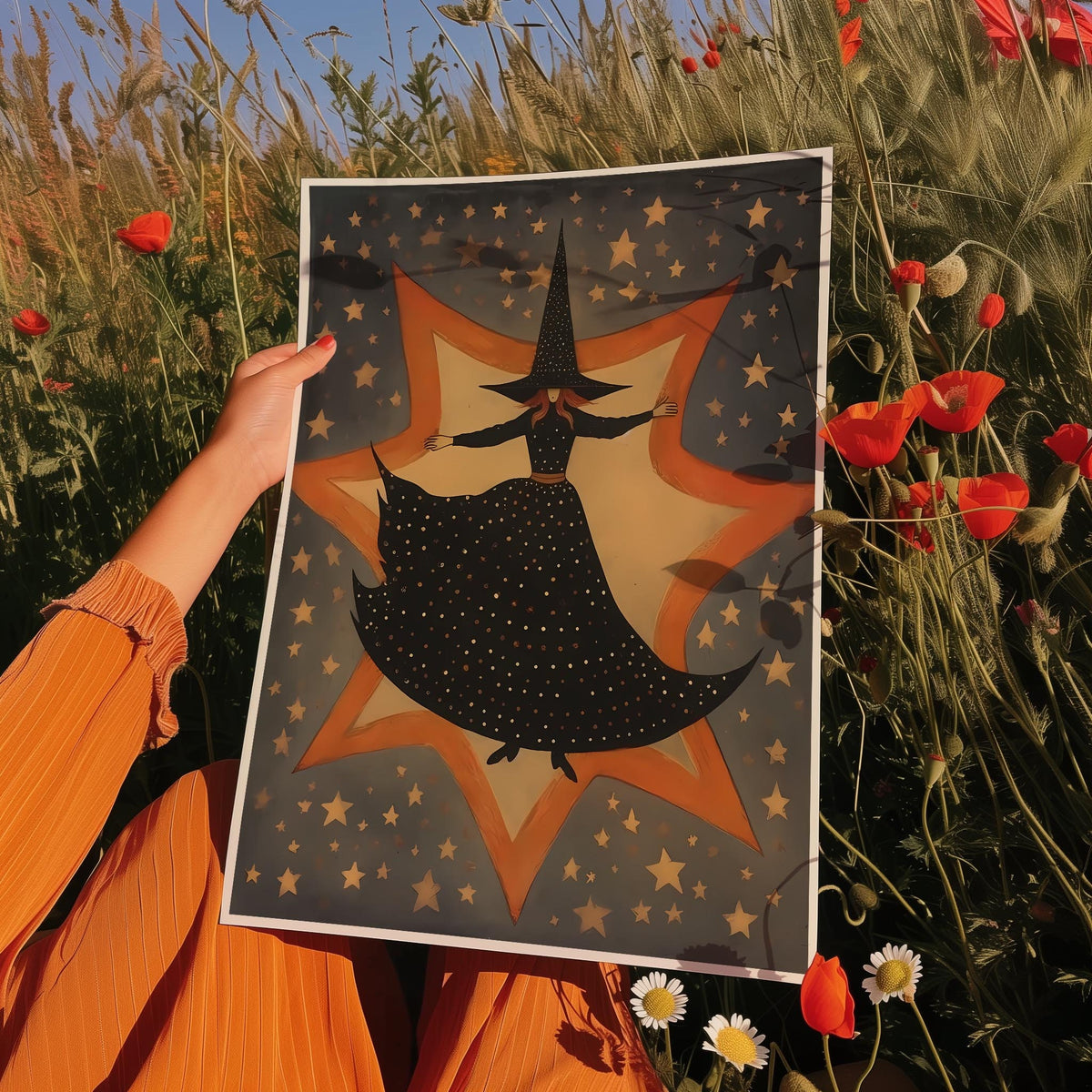 a person holding up a picture of a witch in a field of flowers