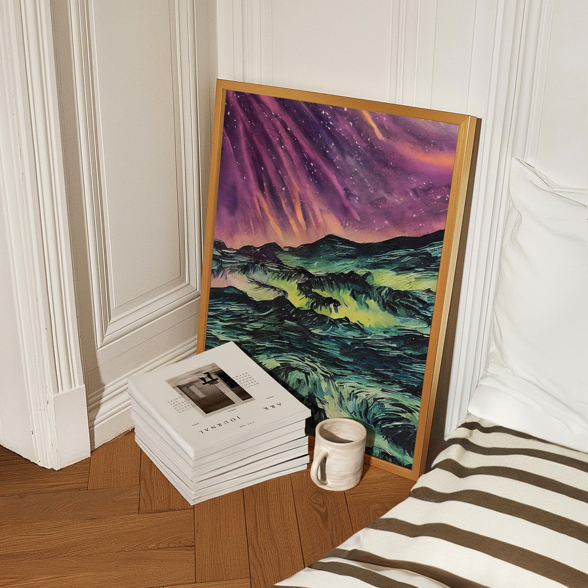 a stack of books sitting on top of a wooden floor next to a painting