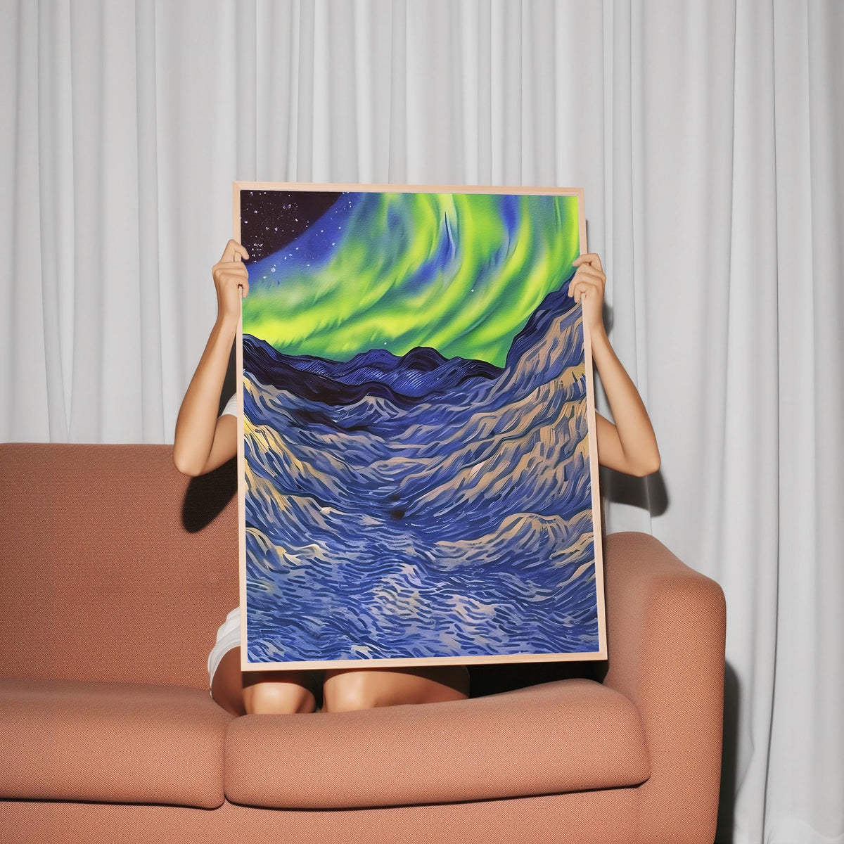 a woman sitting on a couch holding up a painting