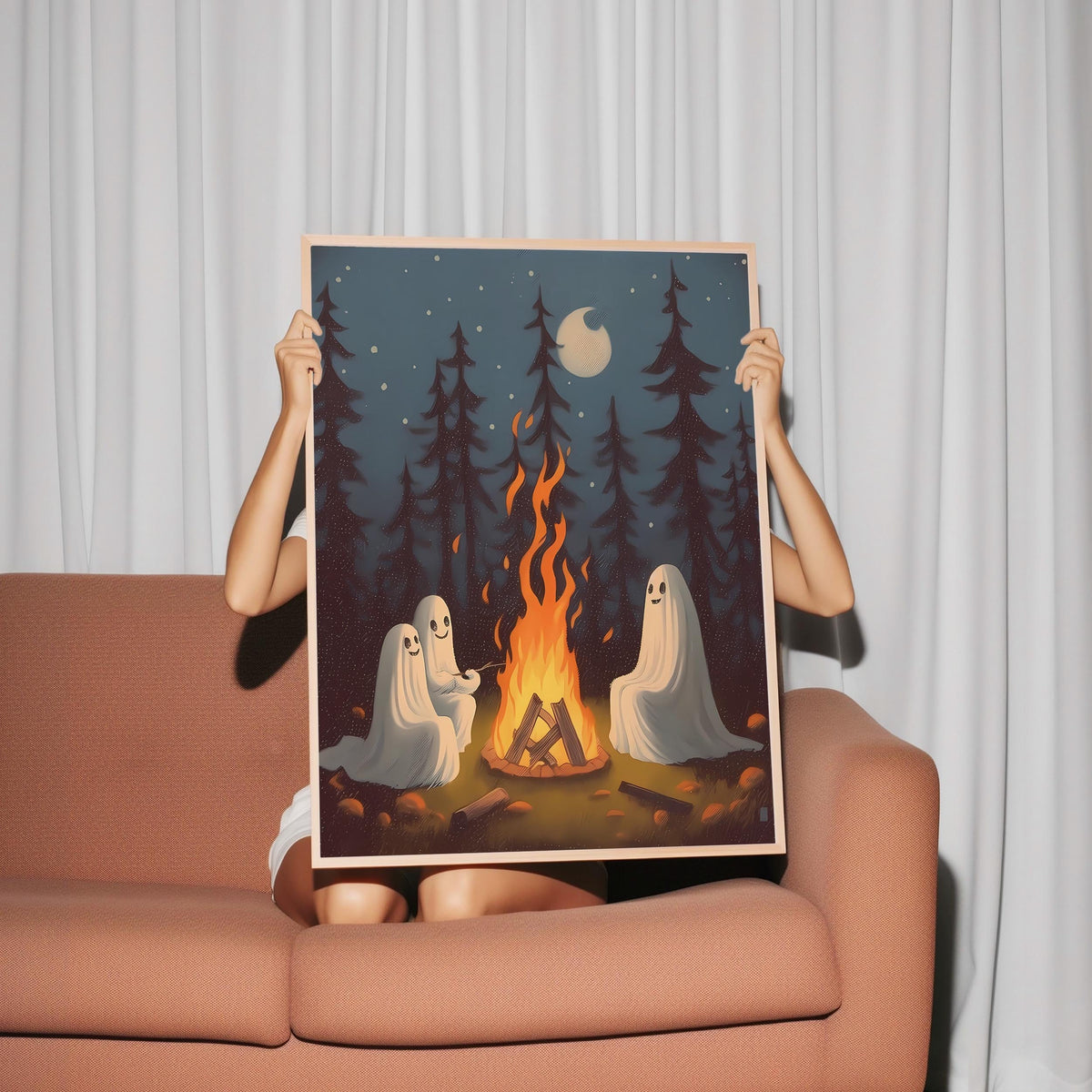 a woman holding up a picture of two ghostes in front of a campfire