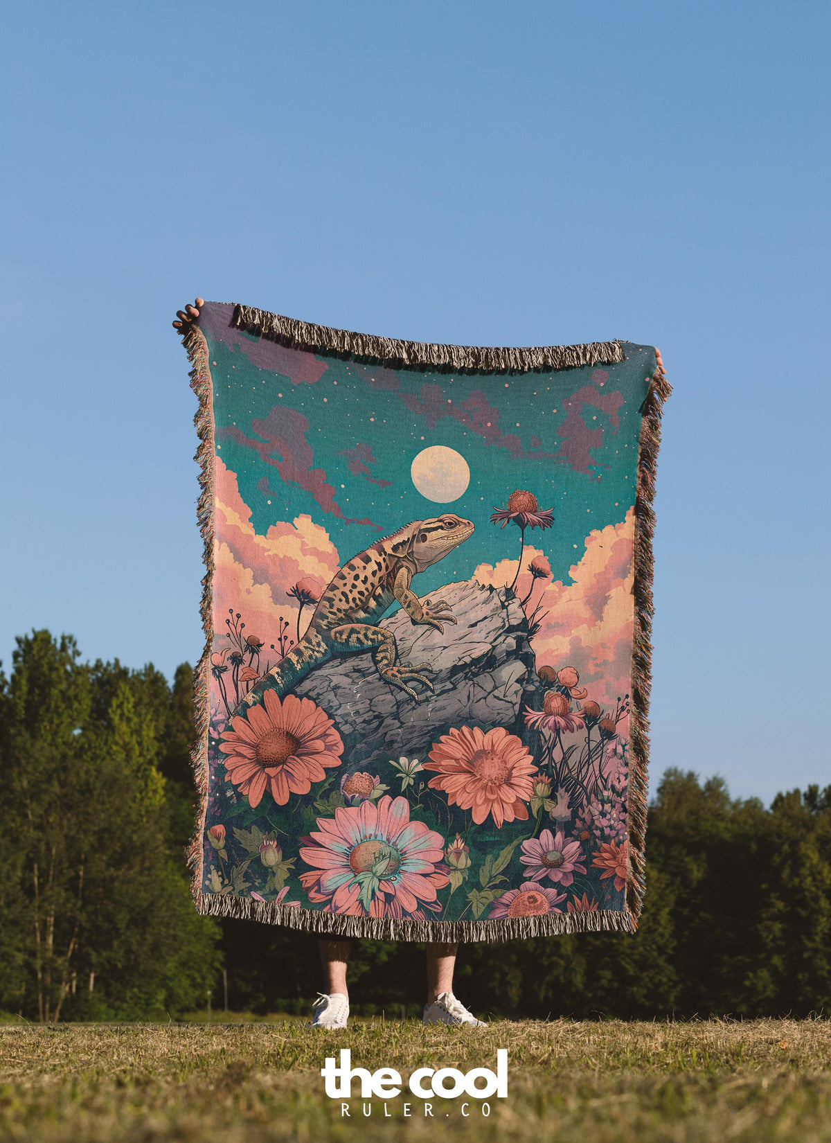 a person standing in a field holding a blanket