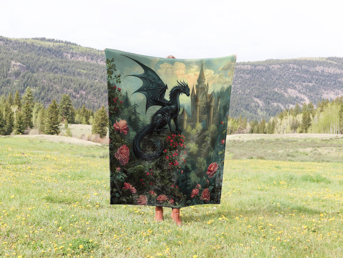 a black dragon is on a blanket in a field