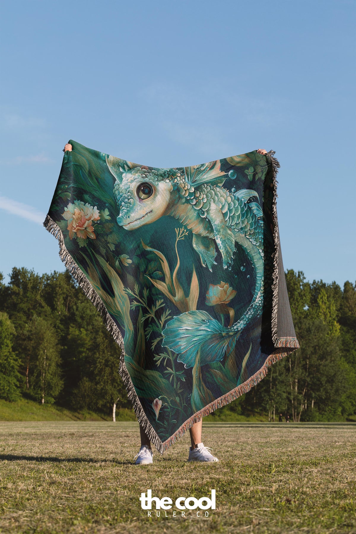 a woman holding a blanket with a picture of an owl on it