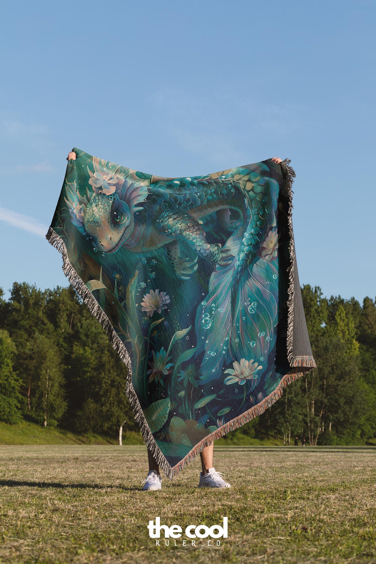 a woman is holding a blanket in a field