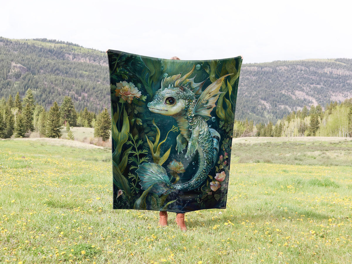 a woman holding up a blanket with a picture of a dragon on it