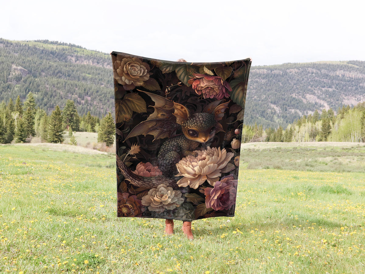 a blanket with a bird and flowers on it