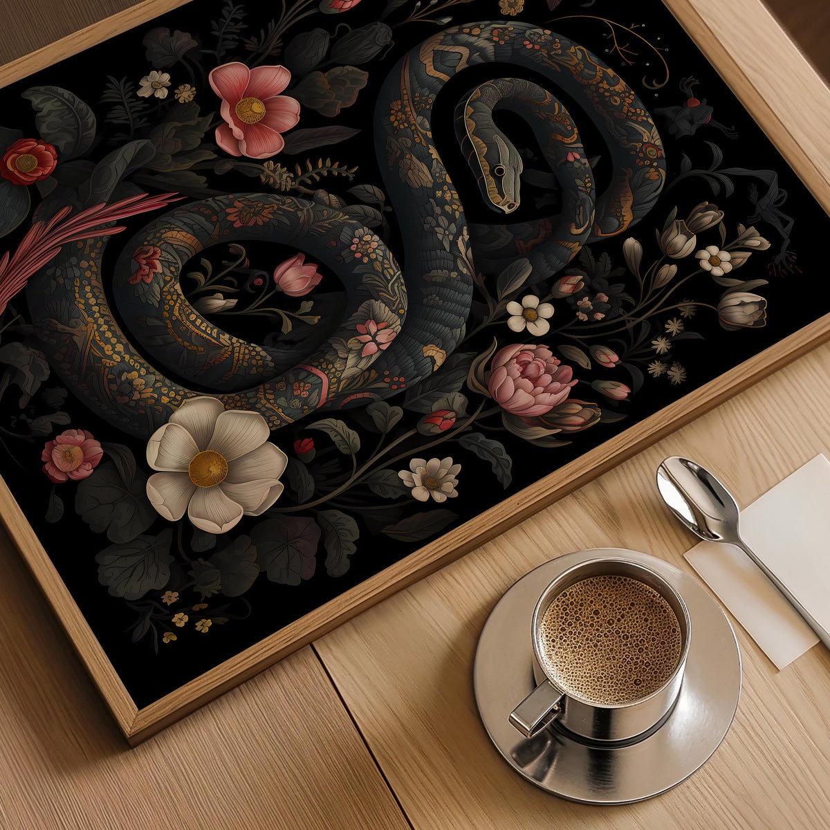 a cup of coffee next to a painting of a snake