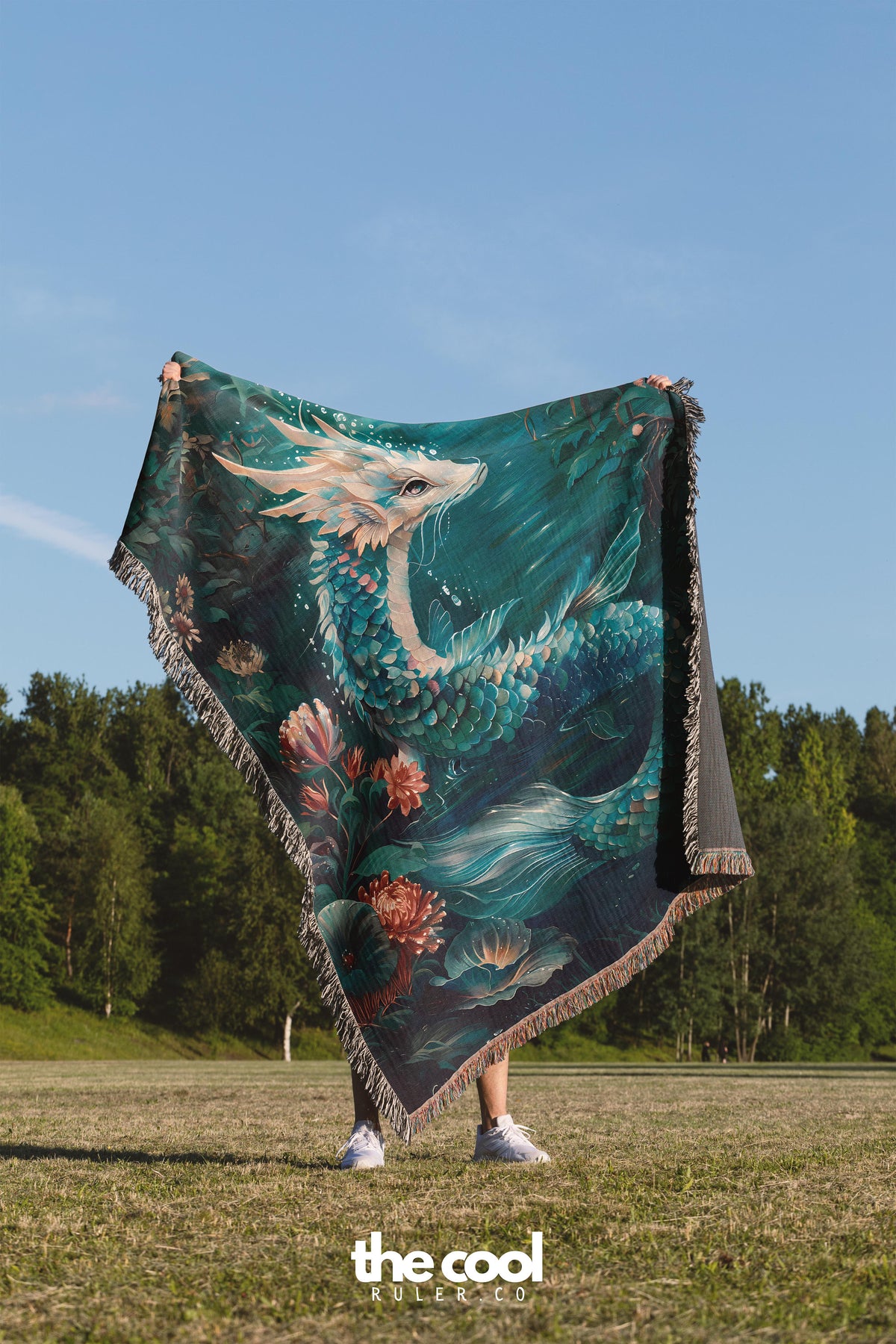 a woman standing in a field holding a blanket