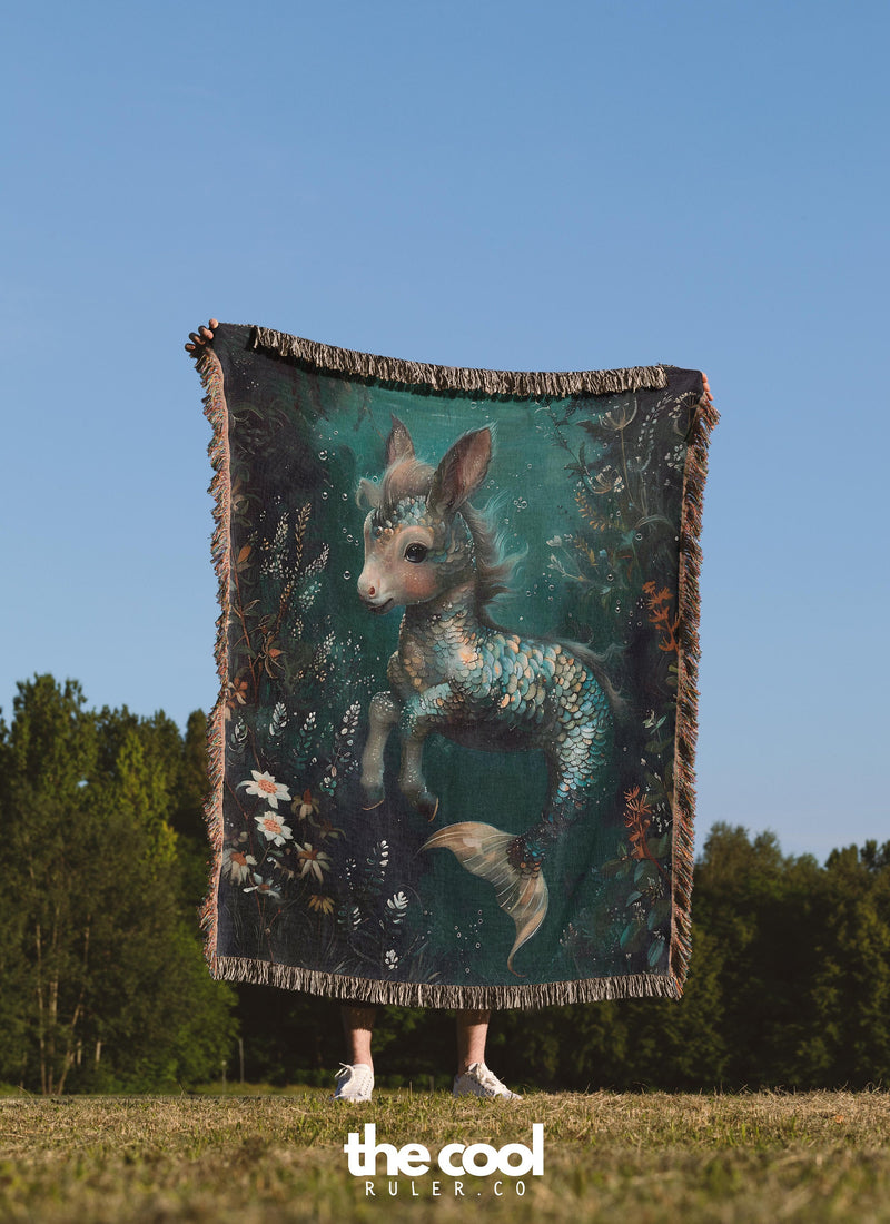 a person holding a blanket with a picture of a deer on it