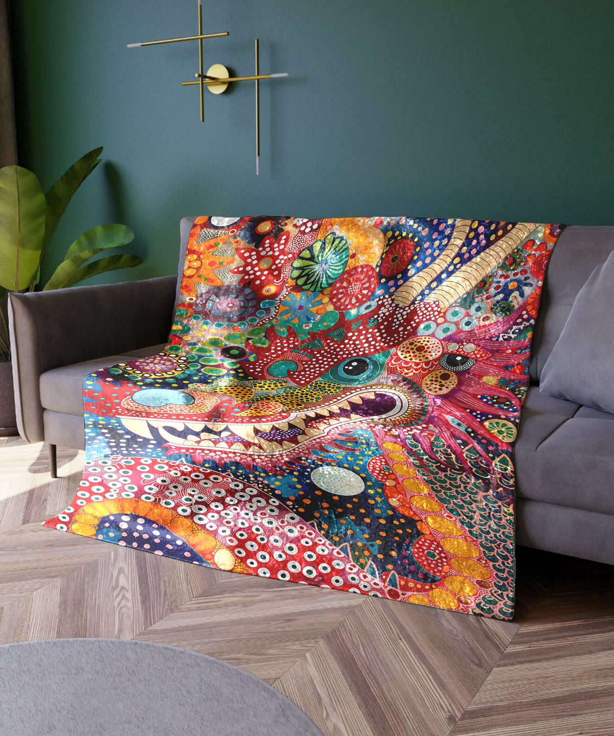 a living room with a couch covered in a colorful blanket