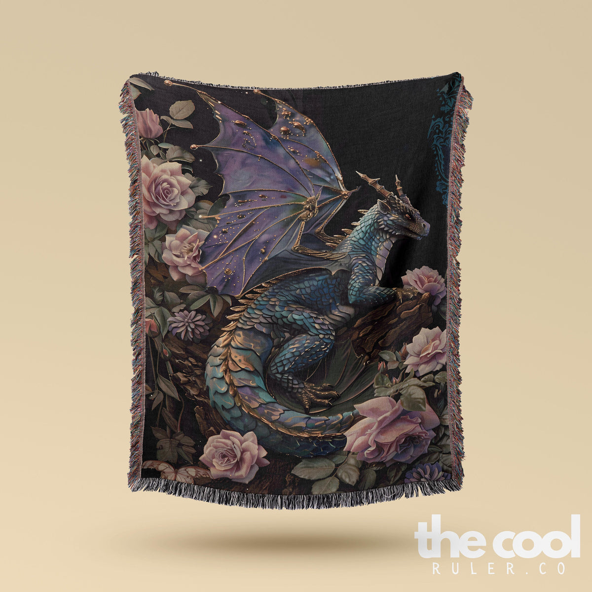 a blue dragon sitting on top of a flower covered blanket