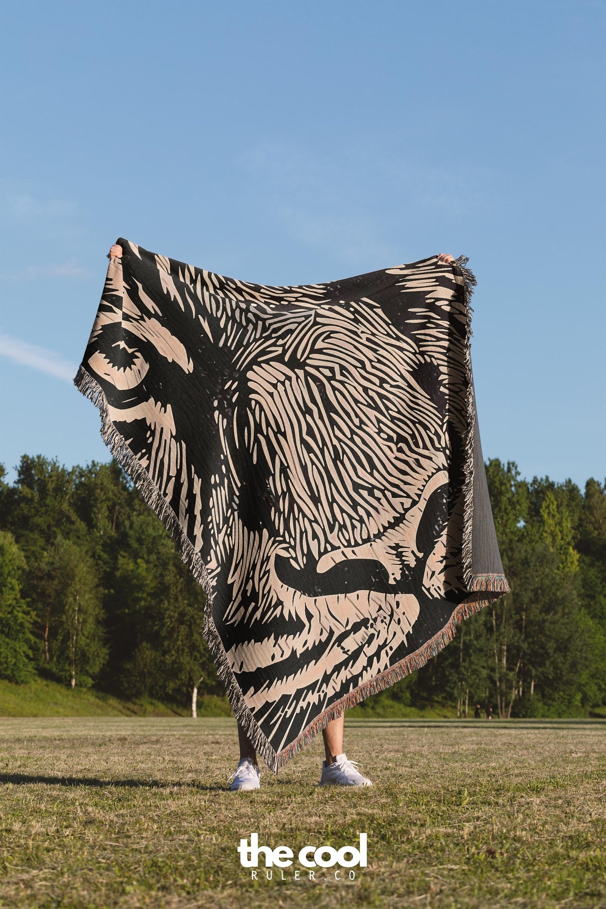 a woman holding a large black and white zebra print blanket